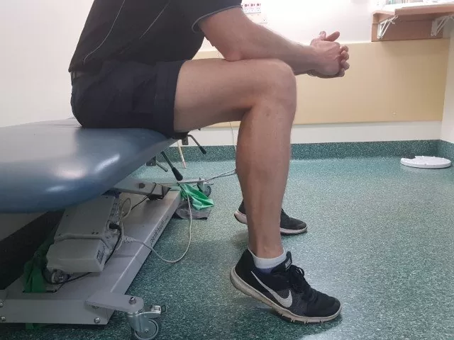 Achilles tendon exercise called seated calf raise - this helps to load the achilles settling symptoms of tendonitis.